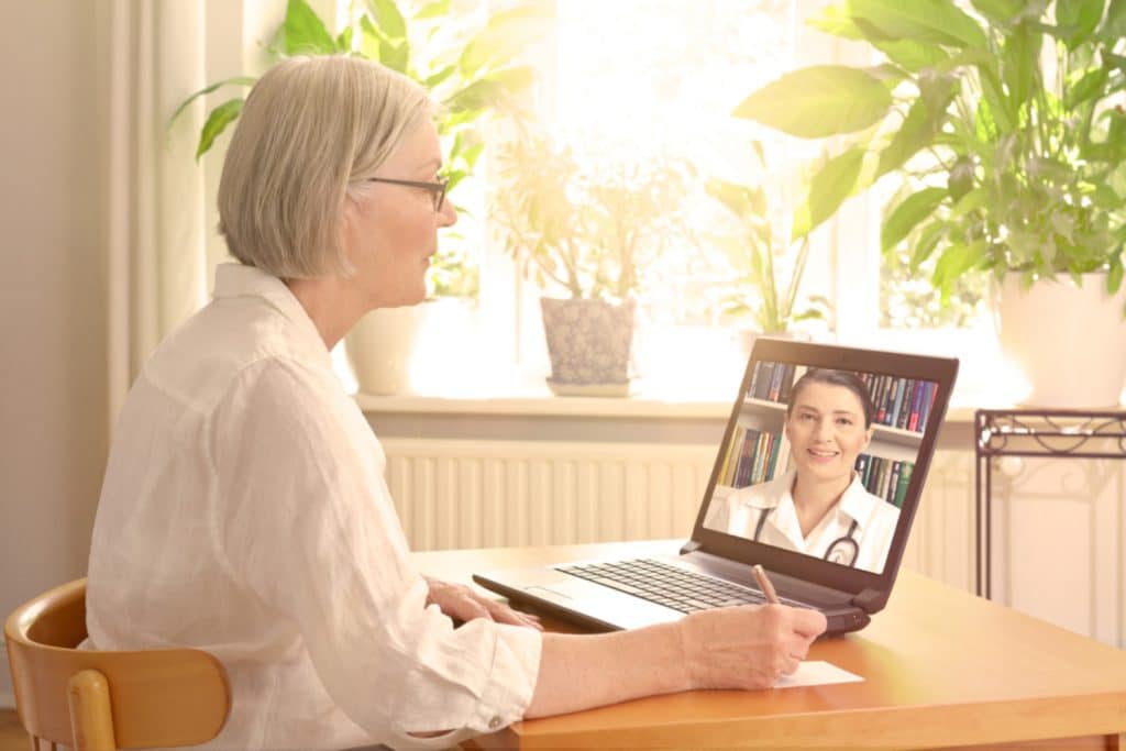 Telemedicine Available in Manhattan New York - Woman having doctor appointment using laptop