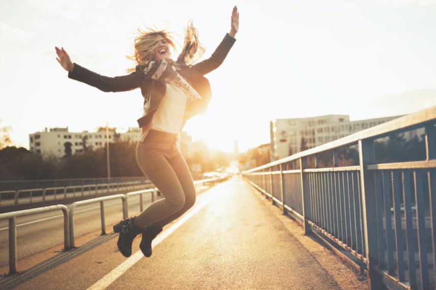 Woman outdoors jumping up in joy - Women's Health Manhattan New York