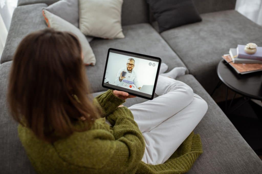 Woman using tablet to speak to doctor - Telemedicine Appointments NYC
