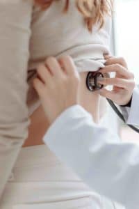 A female doctor examinng her patient with a stethescope.- Maiden Lane Medical I New York, NY