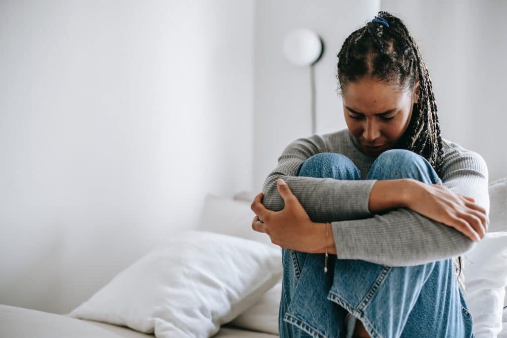 woman in bed suffering from endometrial polyps