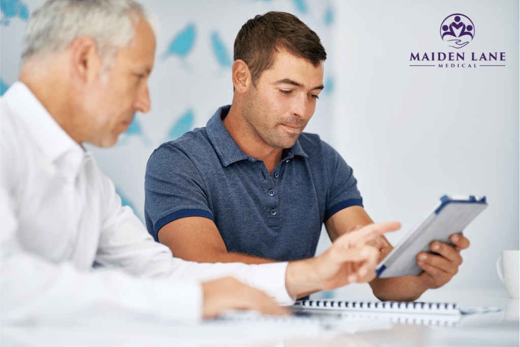A man discussing his fertility evaluation with a specialist in Manhattan, New York.