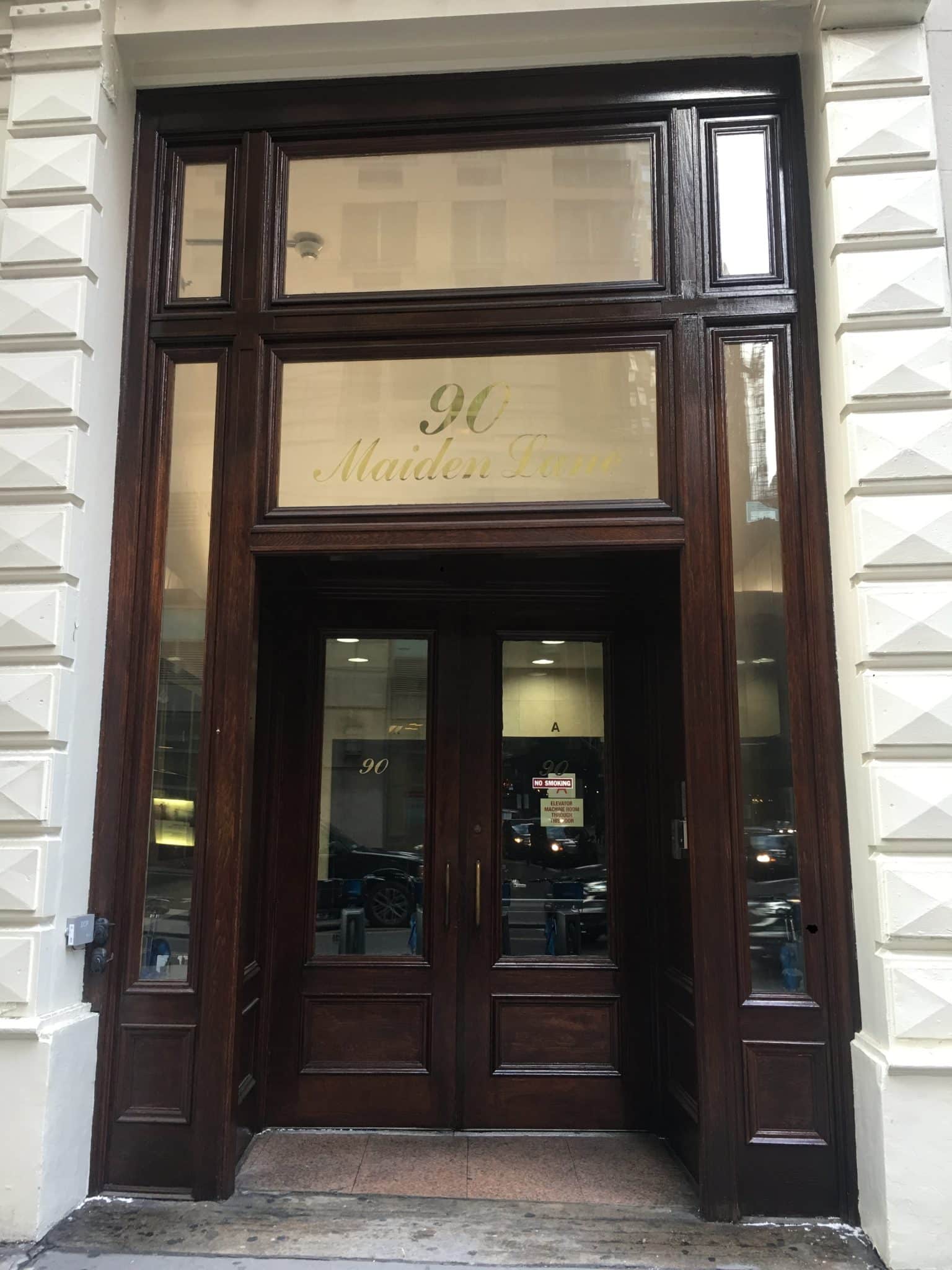 Historic dark wood storefront entrance of the 90 Maiden Lane building in New York City.
