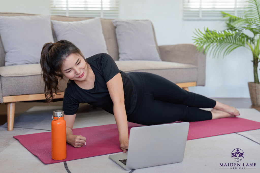 A woman doing exercises during a virtual physical therapy session in New York.